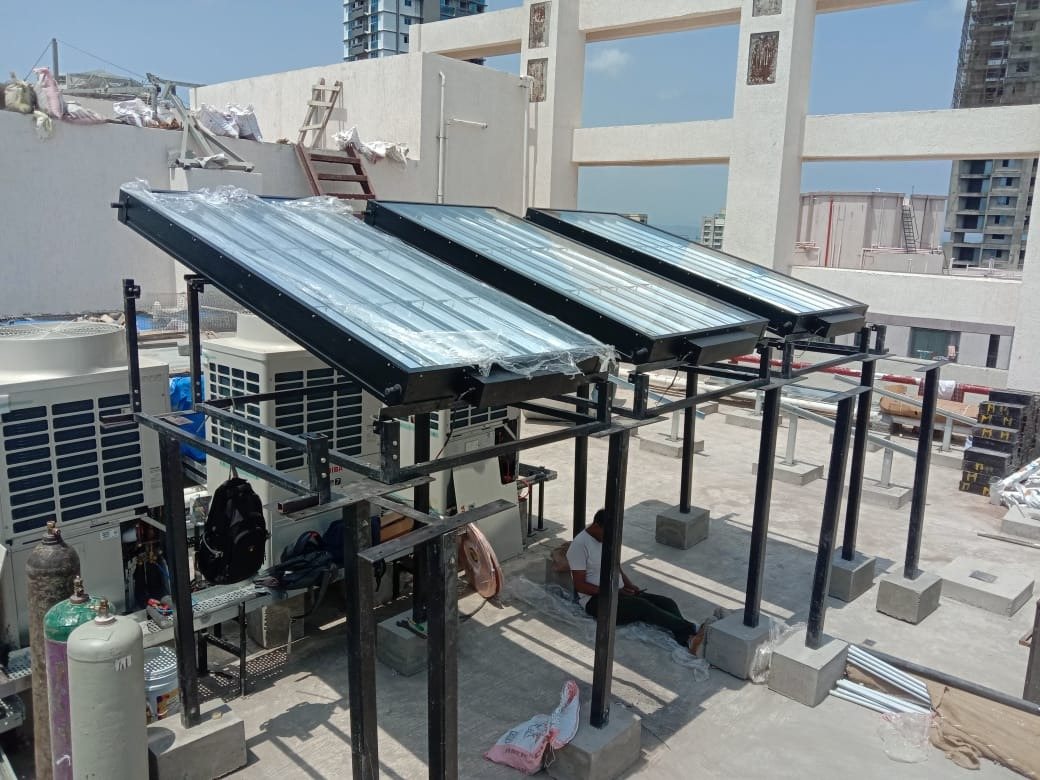 Panels mounted on a steel structure above VRF outdoor units